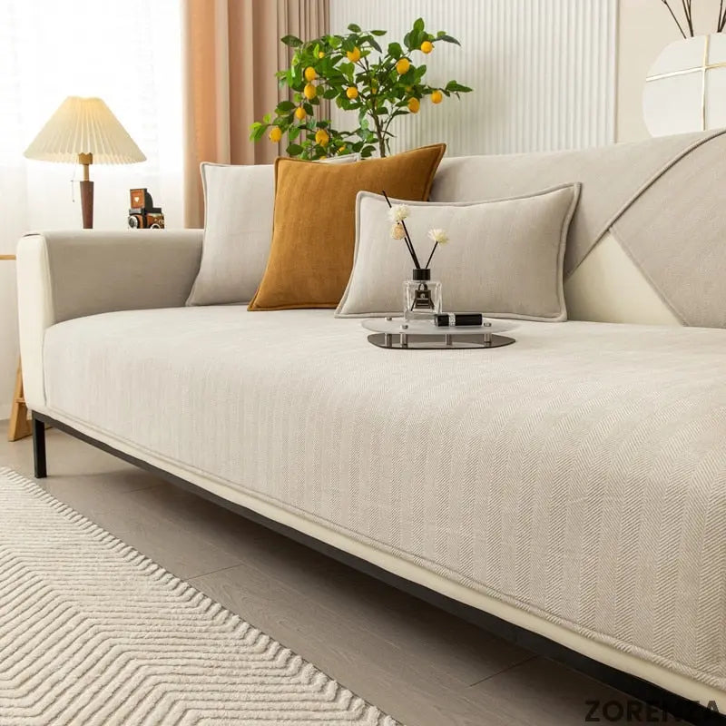 Elegant non-slip sofa cover in a soft gray fabric, designed for a cozy living room refresh. Features a textured pattern for added style and durability, ensuring 1